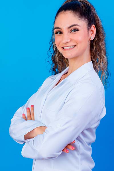 женщина врач улыбается и смотрит в камеру